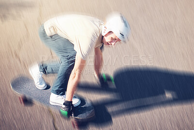 Skate, motion blur and speed with a sports man skating on a road outdoor from above. Skateboard, soft focus and fast with a young male athlete or skater training outside on an asphalt street