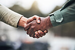 People, hands and handshake for deal, trust or agreement in partnership, unity or support on a blurred background. Hand of team shaking hands for community, teamwork or collaboration in the outdoors