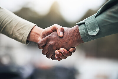 Buy stock photo People, hands and handshake for deal, trust or agreement in partnership, unity or support on a blurred background. Hand of team shaking hands for community, teamwork or collaboration in the outdoors