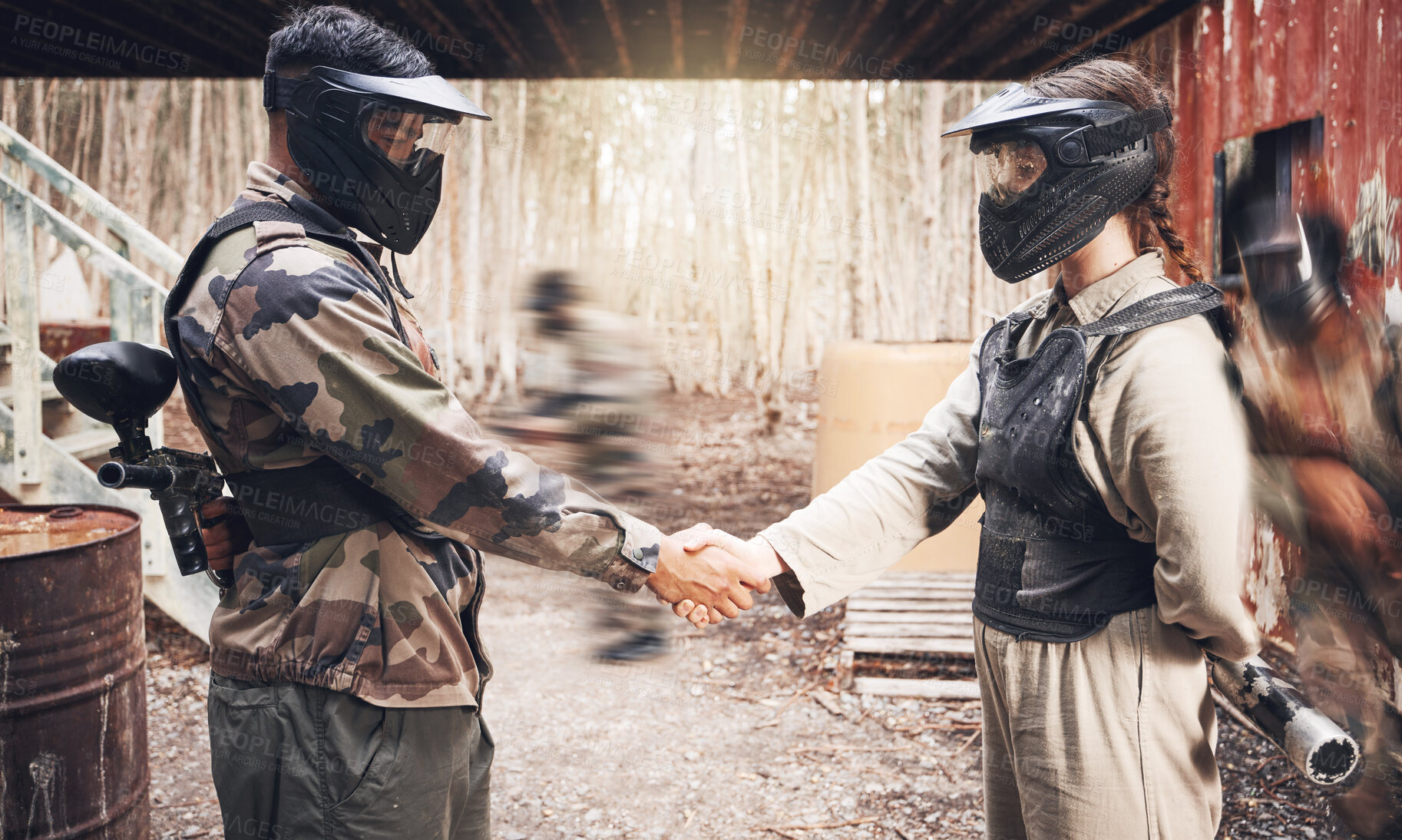 Buy stock photo Handshake, paintball team and congratulations or support, sports game on battlefield and partnership with agreement. Mask for safety, speed and gun, people together on shooting range with trust