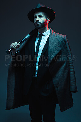 Buy stock photo Fashion, criminal and man in studio with bat for vintage, retro and Victorian gangster on dark background. Crime aesthetic, thinking and male model with luxury clothes, designer and elegant suit