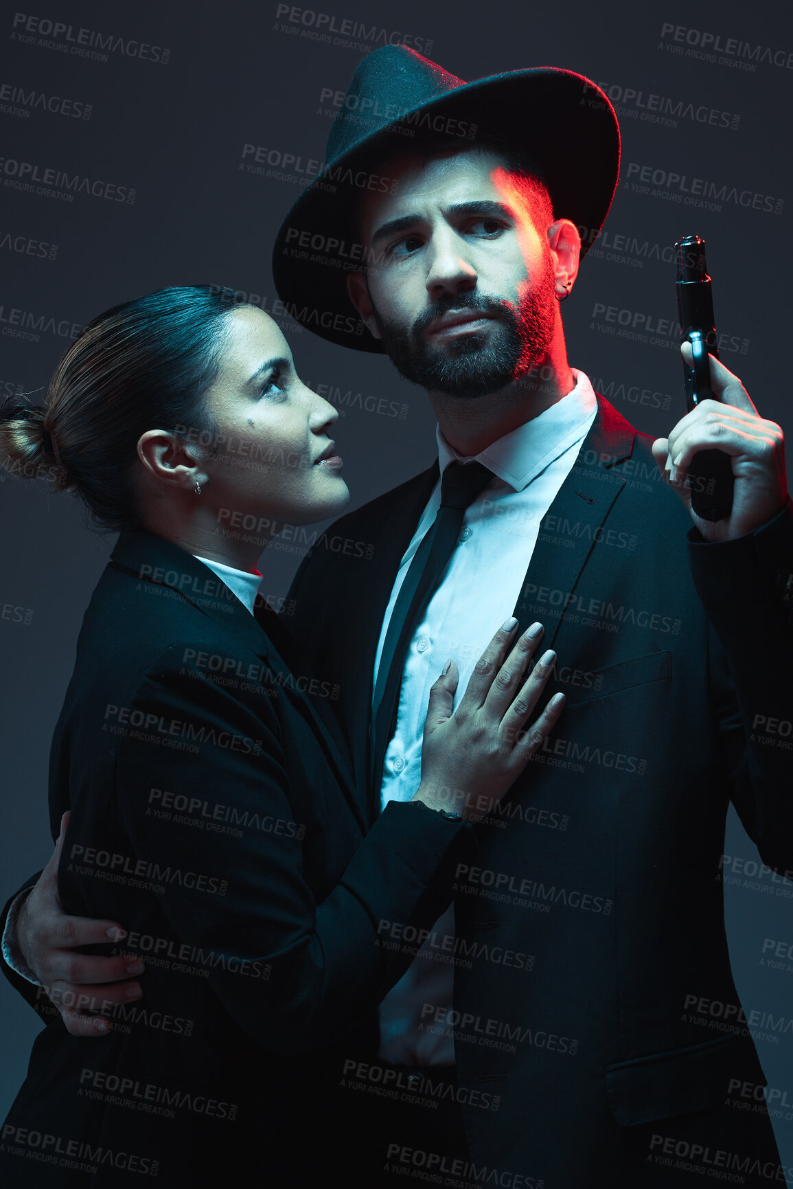 Buy stock photo Couple, fashion or gun on dark studio background in secret spy, isolated mafia safety or crime lord security. Gangster love, woman or model with weapon in stylish, trendy or fashion clothes aesthetic