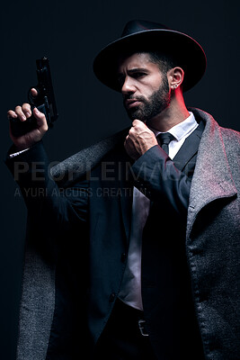 Buy stock photo Gangster, leadership or holding gun on studio background in dark secret spy, isolated mafia or crime lord security. Model, man and hitman suit with weapon in formal style or fashion clothes aesthetic