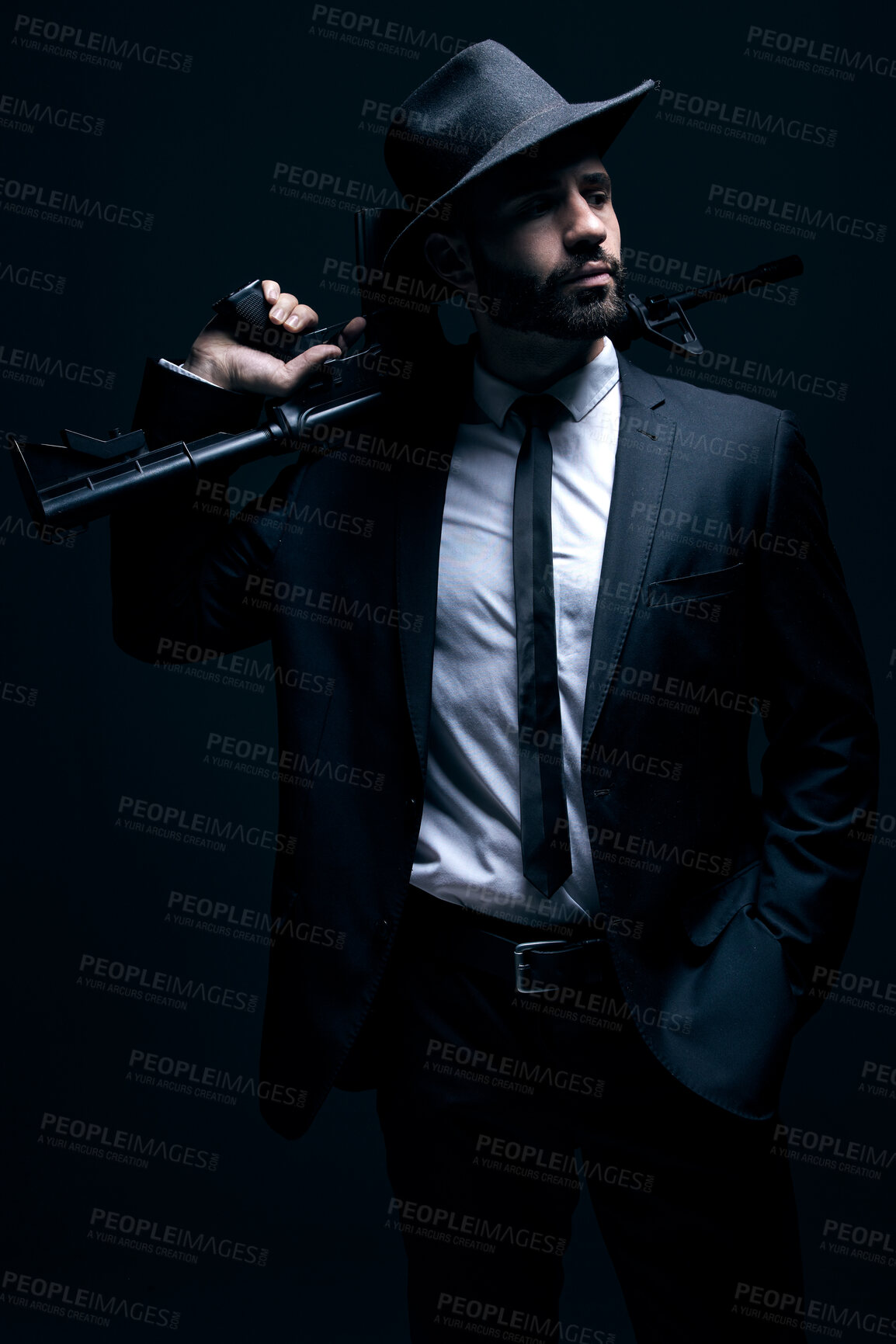 Buy stock photo Hitman, suit or holding gun on studio background in dark secret spy, isolated mafia leadership or crime lord security. Model, man or gangster weapon in formal, fashion clothes or bodyguard aesthetic