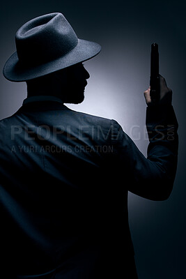 Buy stock photo Gangster, silhouette or holding gun on studio background in secret spy, isolated mafia leadership or crime security. Model, man or dark hitman and weapon suit, fashion clothes or bodyguard aesthetic