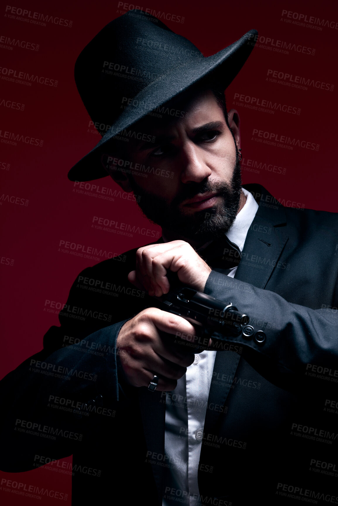 Buy stock photo Gangster, suit or cocking gun on studio background in dark secret spy, isolated mafia leadership or crime safety. Model, assassin or hitman weapon in ready, formal style or fashion clothes aesthetic