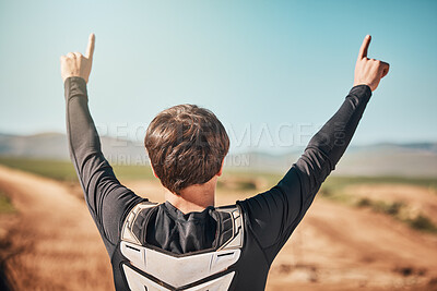 Buy stock photo Winner, hands and back of a sports man outdoor on a dirt track for racing, competition or adrenaline. Success, celebration and winning with a male athlete or biker standing hands raised outside