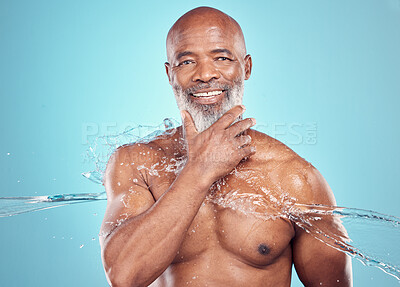 Buy stock photo Grooming, hygiene and portrait of black man with a water splash isolated on a blue background. Shower, smile and elderly African model with a beard for cleaning, body care and wellness on a backdrop