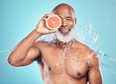Buy stock photo Senior man, skincare and portrait with grapefruit in studio for wellness, grooming or hygiene on blue background. Fruit, product and elderly man in water splash for beauty, luxury and facial isolated