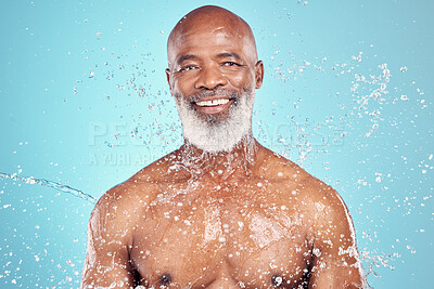 Buy stock photo Grooming, smile and portrait of black man with a water splash isolated on a blue background. Shower, skincare and elderly African model with a beard for cleaning, body care and wellness on a backdrop