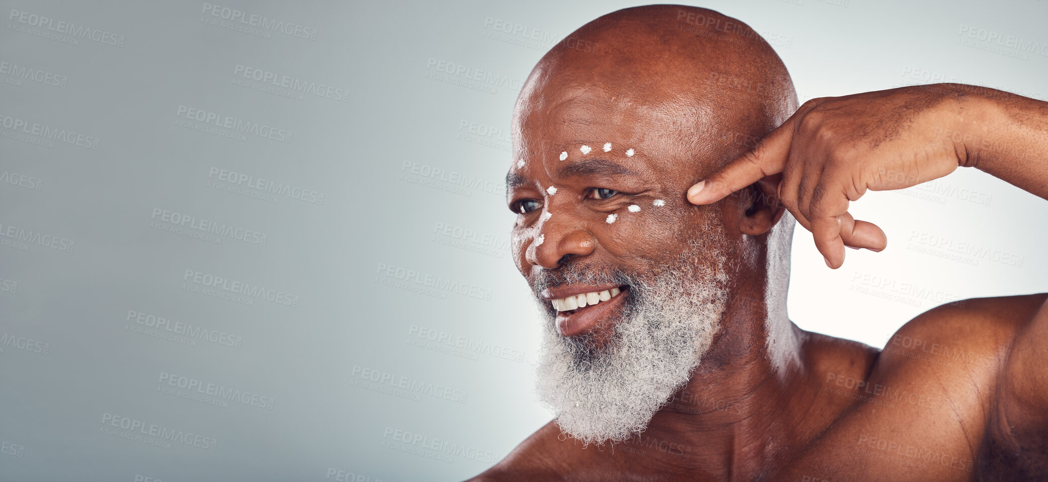 Buy stock photo Skincare, face cream and senior man in studio for wellness, beauty and grooming against grey background. Facial, skin and elderly model relax with luxury, cosmetics and wrinkle product while isolated