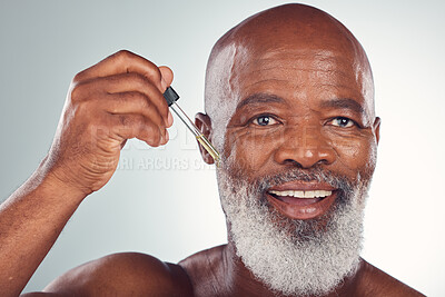 Buy stock photo Cosmetics, black man and serum for skincare, dermatology and guy on grey studio background. African American male or senior gentleman with collagen, oil and treatment for natural beauty or anti aging