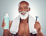 Black man, beard and shaving with razor, cream or cosmetics for skincare, grooming or self care against gray studio background. Portrait of happy African American male with shave kit for clean facial