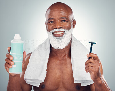 Buy stock photo Black man, beard and shaving with razor, cream or cosmetics for skincare, grooming or self care against gray studio background. Portrait of happy African American male with shave kit for clean facial