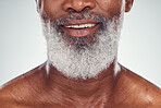 Smile, beard and face with a senior black man grooming in studio on a gray background for beauty or skincare. Skin, hygiene and cosmetics with a mature male indoor to promote facial hair maintenance