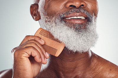 Buy stock photo Grooming, comb and barber with beard of black man for beauty, hygiene and skincare. Self care, facial hair and maintenance with senior model for health, wellness and cleaning in studio background