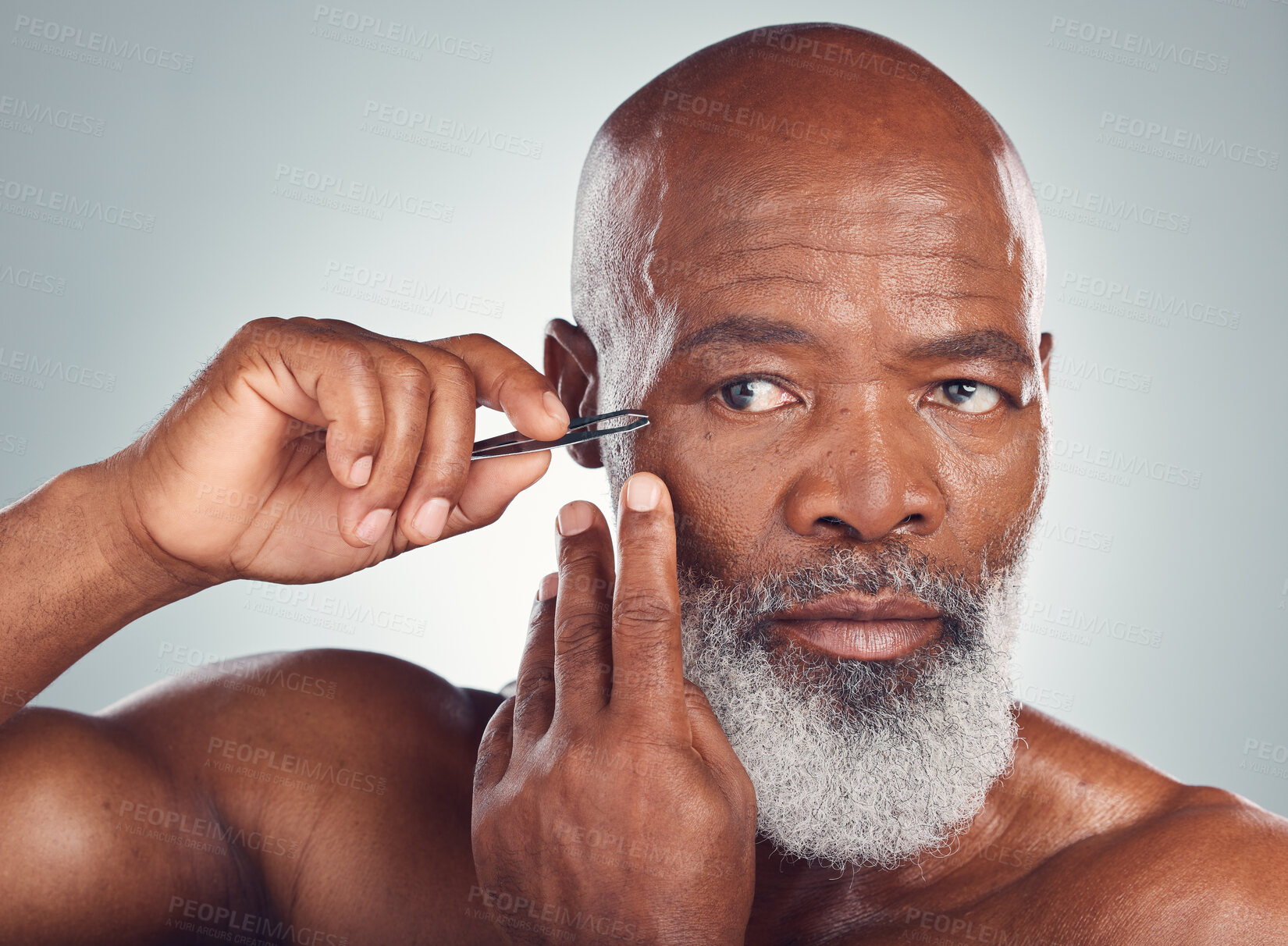 Buy stock photo Grooming, skincare and black man with a tweezers for hair removal isolated on a studio background. Cleaning, beauty and face of an African senior model with a tool for facial care on a grey backdrop