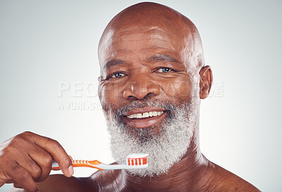Buy stock photo Dental, senior man portrait and toothbrush for oral hygiene in a studio for wellness and health. Gray background, happy face and elderly person with teeth cleaning product and toothpaste product