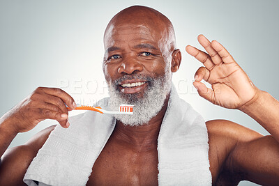 Buy stock photo Black man, toothbrush and yes hand sign, dental and brushing teeth with hygiene isolated on studio background. Mouth care, healthcare and wellness with toothpaste, cleaning and oral health ok