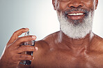 Old man, perfume with skin and smile for beauty, grooming and hygiene isolated on studio background. Happiness, wellness and skincare, cosmetic product and topless with body cologne and fragrance