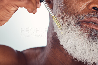 Buy stock photo Closeup, black man and serum for beard, cosmetics and hygiene for wellness, natural beauty and grey studio background. Senior male, mature guy and oil for hair care, grooming routine and treatment