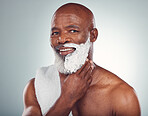 Black man, face and shaving cream, smile in portrait for beauty and grooming isolated on studio background. Facial hair removal, happy elderly person and hygiene with skincare, glow and wellness