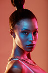 Neon lighting, cyberpunk and portrait of a woman with makeup isolated on a brown studio background. Fashion, futuristic and face of a model with creative beauty, coametics and glow on a backdrop