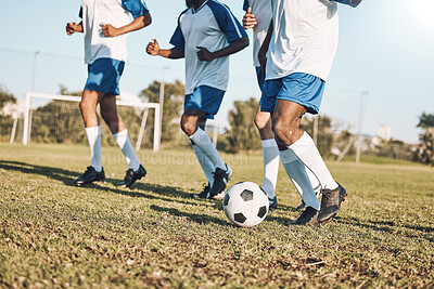 Sports, soccer and team playing on the field at a game competition, league or championship. Fitness, football and male sport players running with a ball at an outdoor match on the soccer field.