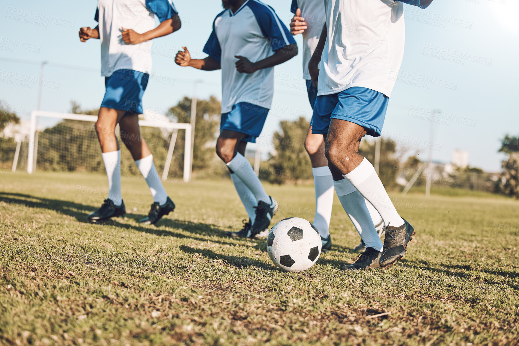 Buy stock photo Sports, soccer and team playing on the field at a game competition, league or championship. Fitness, football and male sport players running with a ball at an outdoor match on the soccer field.