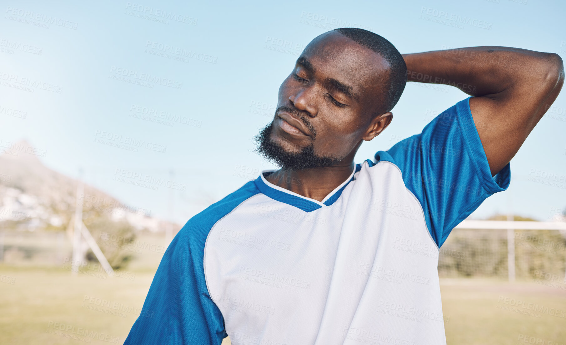 Buy stock photo Soccer, black man and stretching before game, training or exercise for wellness, preparation for match or energy. African American male athlete, guy or football player stretch neck, fitness or sports