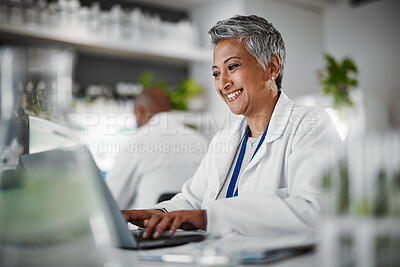 Buy stock photo Scientist, senior woman and lab with laptop, research and plants with analytics, pharmaceutical study and focus. Elderly science expert, computer and typing for data analysis for goal in laboratory