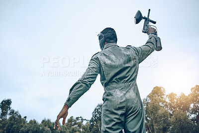 Buy stock photo Paintball gun, winner person and blue sky mockup for success in battlefield game, outdoor sports or adventure. Shooting, war and fitness man in safety gear for military training, action and winning
