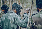 Training, paintball and man with hand sign for planning, strategy and plan of action outdoor. Military, men and hands by guy leading team in sports, shooting and intense target practice together
