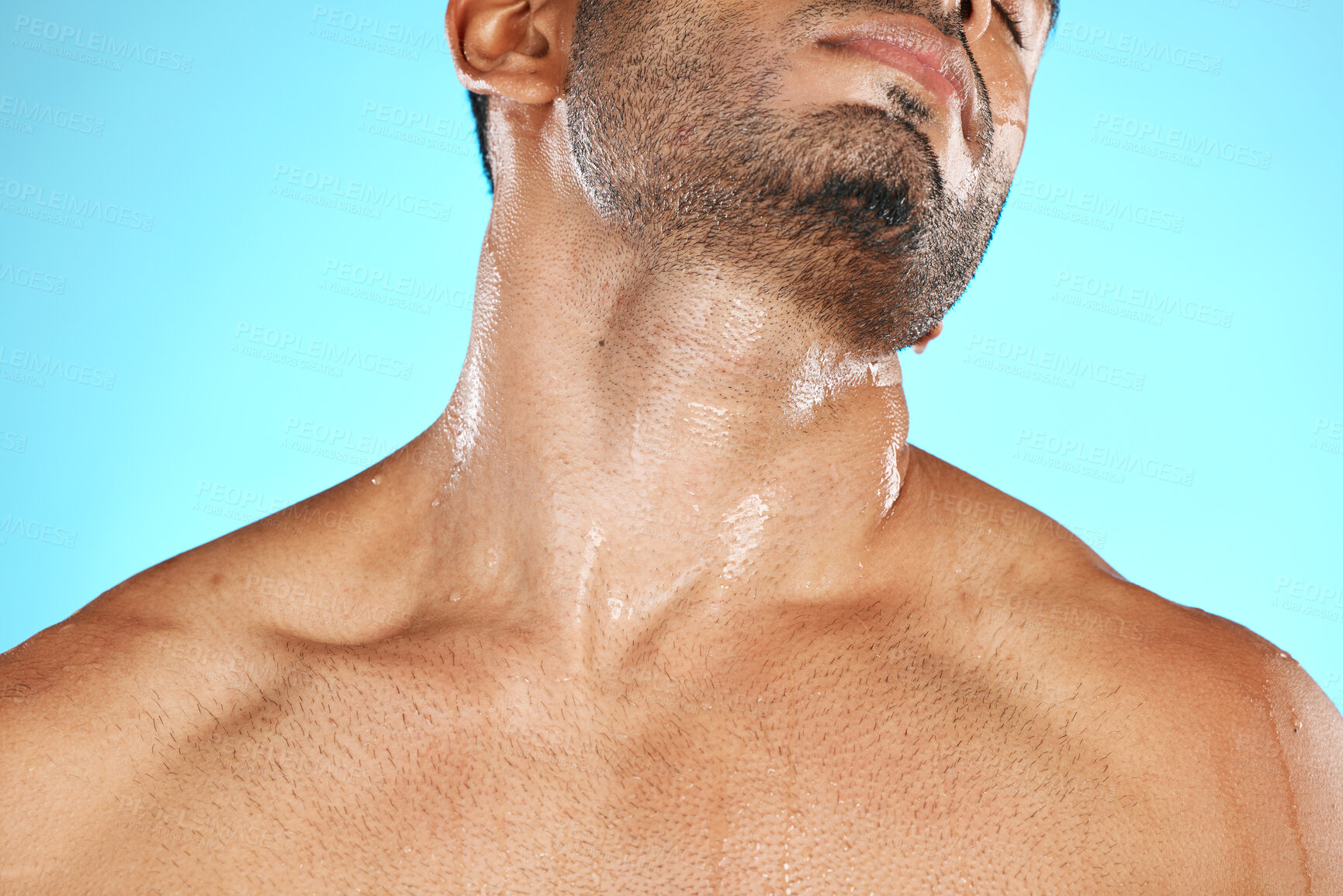 Buy stock photo Skincare, neck and man with cosmetics for wellness, health and washing on blue studio background. Male, gentleman and wet shoulders for natural beauty, hygiene and cleaning for smooth and soft skin