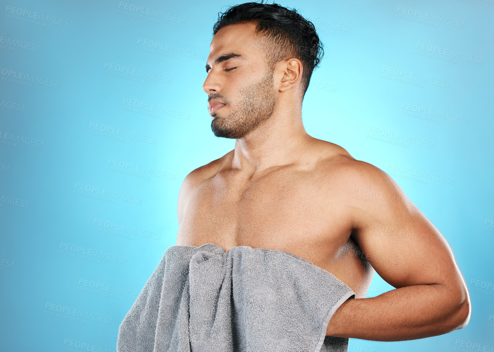 Buy stock photo Skincare, man and clean with towel, cosmetics and wellness for body care on blue studio background. Male, gentleman and cloth for drying, natural beauty and hygiene grooming routine and treatment