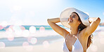 Travel, beach and woman on summer, vacation and holiday against bokeh, water and nature background. Happy, freedom and girl relax at the ocean, fun and smile while enjoying freedom, sun and joy