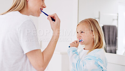 Buy stock photo Mom, girl and brushing teeth together in bathroom, learning and support with foam for wellness in family house. Toothbrush, mother and daughter with toothpaste, teaching and care for cleaning mouth
