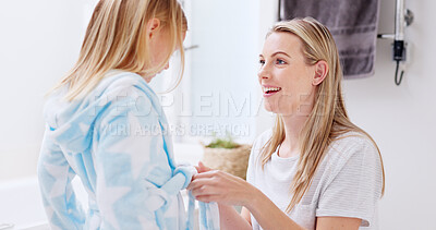 Buy stock photo Mother, help and child with bathrobe in bathroom for cleaning, wellness and hygiene in the morning in home together. Smile, care and woman talking with kid after shower, washing and relax for beauty