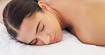 Spa, wellness and woman, calm and happy, peaceful after massage, massage therapy for body health and zen. Young person satisfied, lying down and carefree with peace and serene, stress relief.