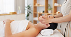 Woman, relax and spa for facial, massage or beauty in healthy skin, wellness or luxury treatment at resort indoors. Female in calm, zen or physical therapy relaxing on massaging table for skincare