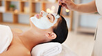 Skincare, beauty and spa facial with woman face mask at a wellness, health and salon. Relax, luxury and and girl resting while beautician hands apply exfoliation, peeling and hydration skin product