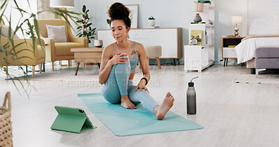 Exercise, yoga and tablet with fitness woman streaming online class, tutorial or live stream on internet virtual training in lounge at home. Fit female using technology for spiritual wellness workout