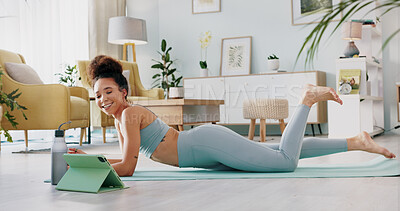 Yoga, woman and tablet for wellness, zen and mindfulness on floor in home, apartment or house. Black woman, stretching and exercise for wellness, health and fitness from class on internet, app or web