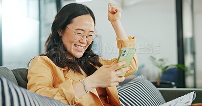 Business woman, phone or success fist on working office sofa, digital marketing startup or Asian advertising company. Smile, happy or winner creative designer on mobile technology or cheering goals