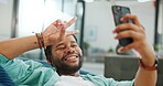 Black man, phone and peace sign on video call with smile for social, networking or communication at the office. African American man relaxing on break talking on smartphone videocall at the workplace