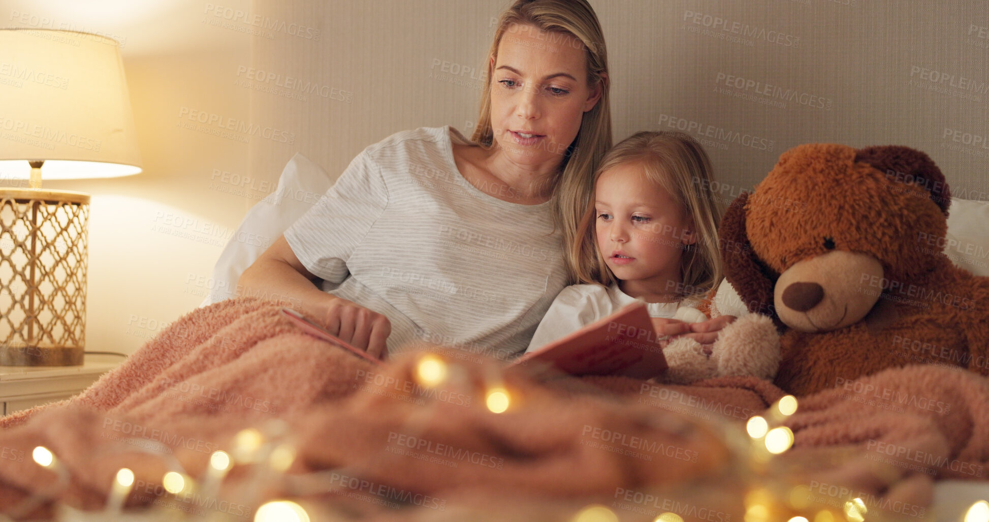 Buy stock photo Mom, girl and book on bed, night and reading with learning, knowledge and relax together in family home. Bedtime story, mother and daughter in bedroom, fantasy and together with care, bonding or love