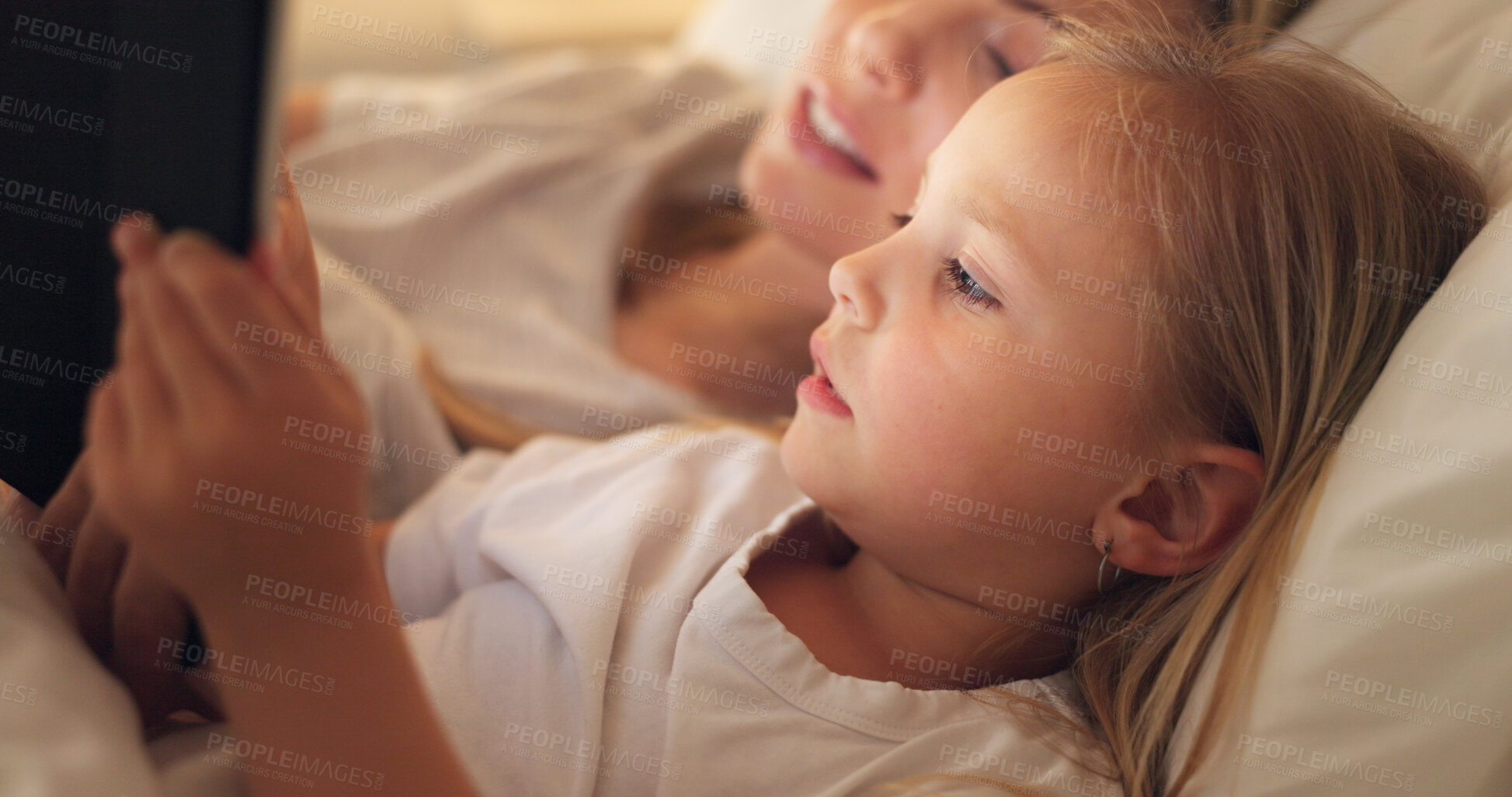 Buy stock photo Mom, girl and tablet in bedroom, night and reading with learning, video or movie to relax together in family home. Bedtime story, mother and daughter on bed, cartoon and care with love for bonding