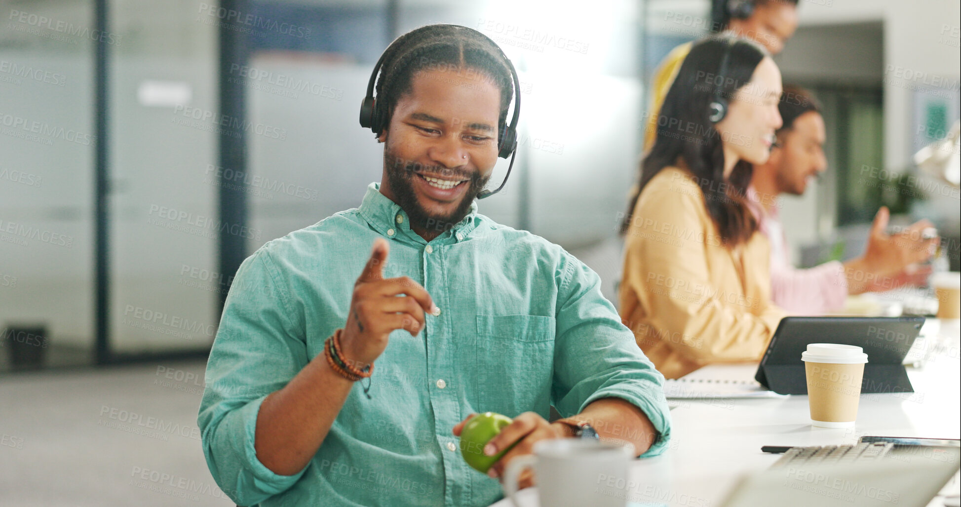 Buy stock photo Call center, smile and a black man with an apple while working on a computer for sales or communication. Telemarketing, contact us and online support with a male employee as a consultant with fruit