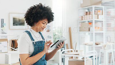 Black woman, online shopping and tablet at warehouse office scroll for free shipping order delivery shipment information. African girl worker, logistics and tech working for internet ecommerce shop