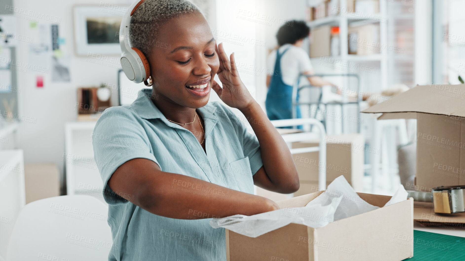 Buy stock photo Ecommerce, woman packing boxes with headphones in office for sales and delivery at startup with smile. Online shopping, package and small business owner with music, product and web store in Africa.